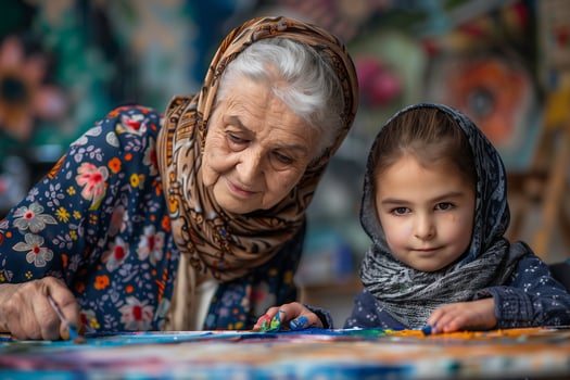 An older woman and a young girl painting photo
