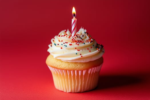 Festive cupcake with a candle and colorful sprinkles for a birthday celebration photo