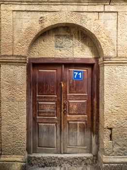 Vintage brown wooden door in a mountain authentic village photo