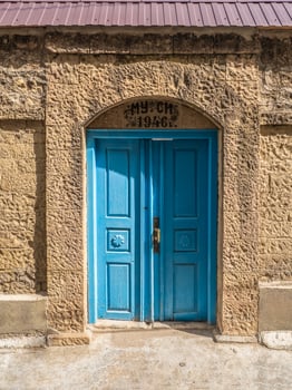 Vintage blue wooden door in a mountain authentic village photo