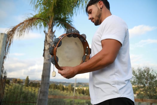 Skilled Tambourine Player in Vast Countryside photo