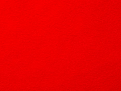 A red background with a red object in the foreground photo