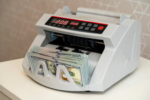 Currency counting machine in use for efficient cash handling photo