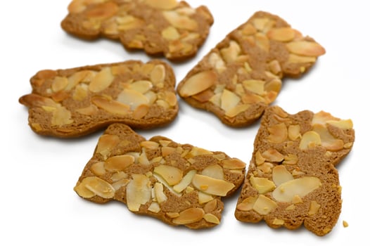 Delightful almond cookies arranged artfully on a white surface inviting sweet cravings and indulgence photo