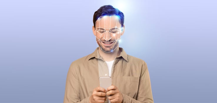 A person is engaged with a smartphone, using modern facial recognition technology. photo