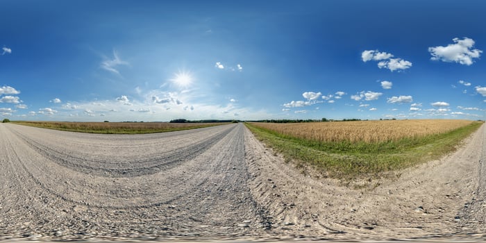 hdri 360 panorama of blue sky with awesome clouds on road among fields in equirectangular full seamless spherical projection, for VR AR content or skydome replacement photo