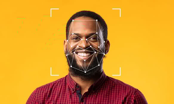 A man smiles widely while facial recognition technology analyzes his features. photo