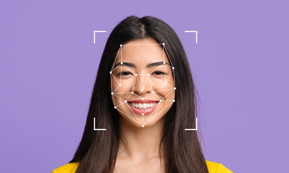 A young woman smiles confidently as facial recognition technology overlays geometric lines on her face. This depiction highlights advances in ID identification and recognition methods. photo