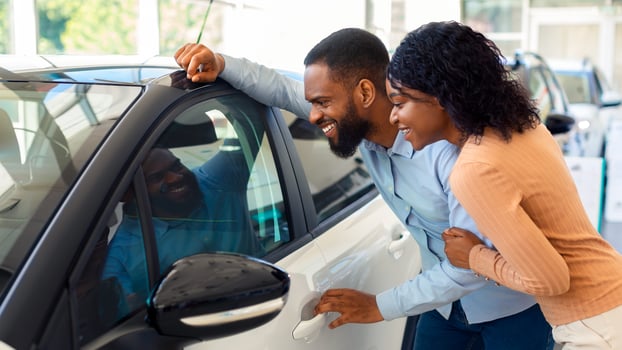New Car. Excited Black Spouses Looking At Their New Automobile In Dealership Office, Happy African American Couple Choosing Luxury Vehicle In Showroom, Checking Automobile Interior, Closeup photo