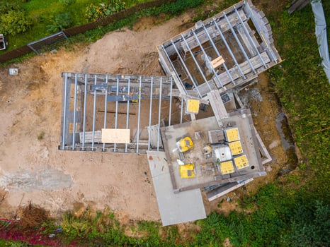 Aerial View of Construction Site with Steel Framework and Materials photo