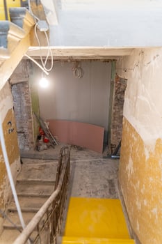 Indoor Construction Site with Exposed Brick and Yellow Step photo