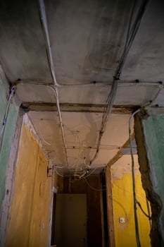 Interior Under Renovation with Exposed Wiring and Faded Walls photo