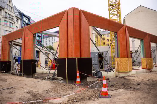 Urban Construction Site with Steel Framework and Yellow Crane photo