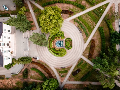 Aerial View of Symmetrical Garden with Circular Fountain and Pathways photo