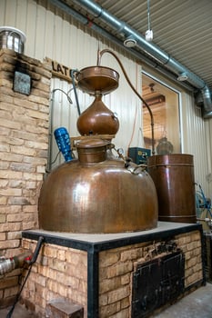 Traditional Copper Distillation Apparatus in Rustic Indoor Setting photo