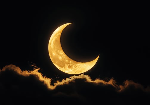 crescent moon glowing above clouds 1 photo