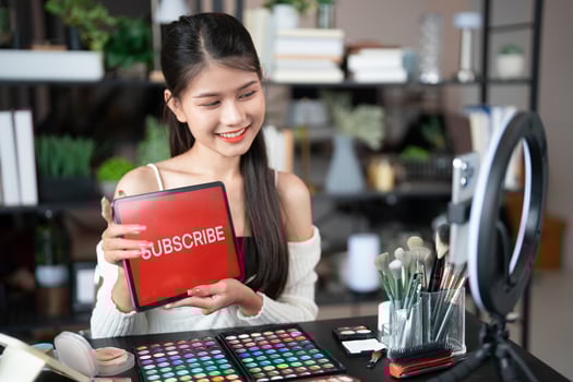 Online marketing Beauty influencer Asian girl Using Social Media for live streaming on Smartphone online audience like and subscribe to her channel. Like Follower. photo