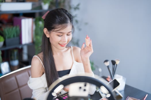 beautiful asian woman using makeup mirror photo