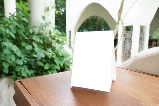 Menu mock up blank for text marketing promotion. Mock up Menu frame standing on wood table in restaurant for text. photo
