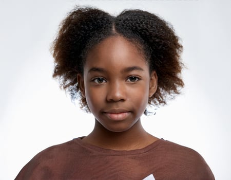Close Up Portrait of African Teenager with Side Part and Hairstyle on White Background photo