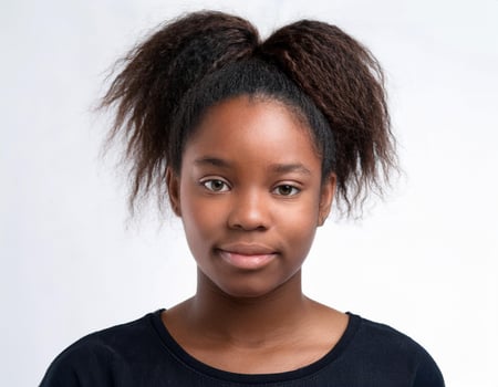 Close Up Portrait of African Teenager with Long Natural Hair and Expression on White Background photo