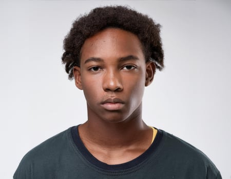 Studio Portrait of African Teenager with Natural Hair in Soft Curls on White Background photo