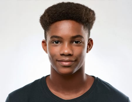 Studio Portrait of African Teenager with Natural Hair and Soft Expression on White Background photo