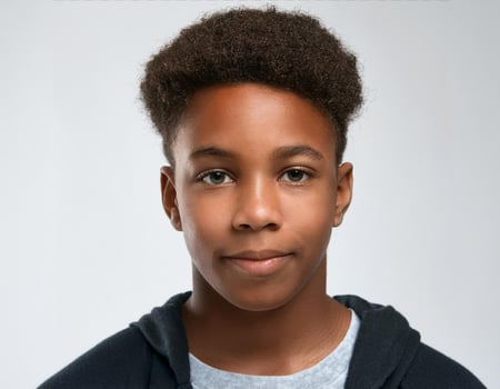 Portrait of African Teenager with Defined Shaved Hairstyle and Clear Skin on White Background photo