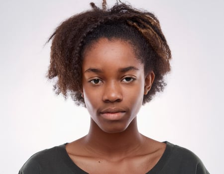 Close Up Portrait of African Teenager with Defined Long Curls and Expression on White Background photo