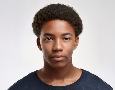 Close Up Portrait of African Teenager with Defined Defined Braided Hairstyle on White Background photo