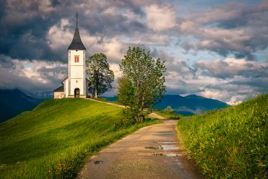Narrow rural road and Saint Primoz mountain church, Jamnik, Slovenia photo