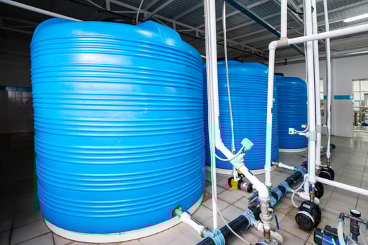 Large blue water storage tanks arranged systematically in a modern facility for liquid management and distribution photo