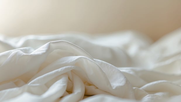 close up of white bedding sheets soft focus and copy space photo