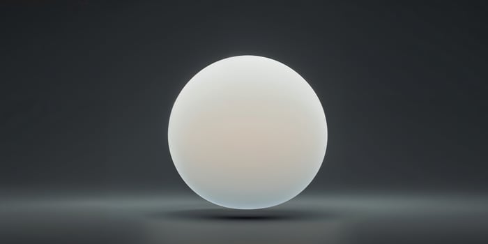 A glowing orb of light centered on a black gradient background. photo