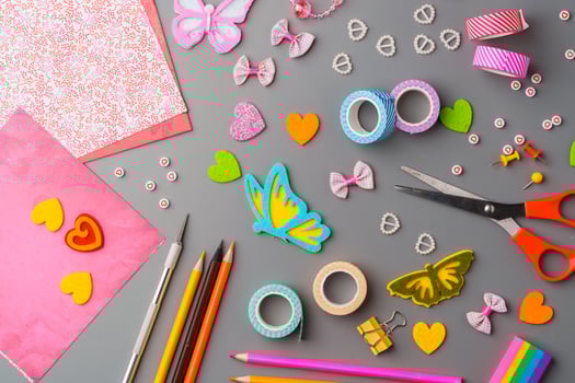 Crafting materials and tools arranged on a gray surface during a creative project photo