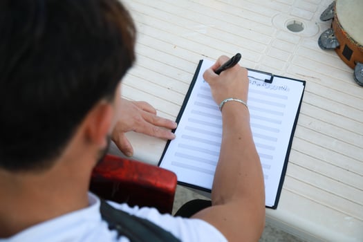 Man Studying Accordion And Watching On The Paper photo