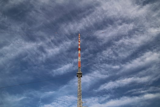 Red and white radio tower in unusual angle. photo