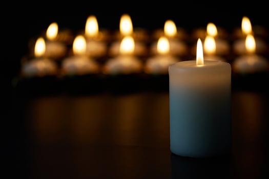 Candlelight Serenity. A peaceful arrangement of glowing candles against a dark backdrop, photo