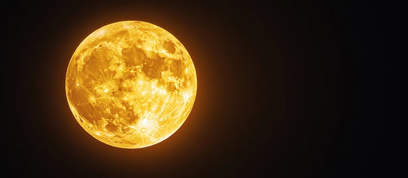 A close-up of the bright, golden moon in a dark night sky. photo