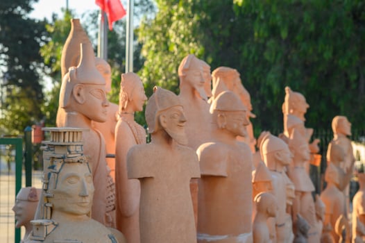 Unique terracotta sculptures representing historical figures in an outdoor display at a cultural site photo