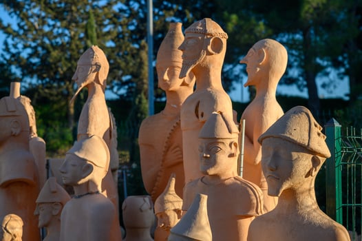 Ancient terracotta warriors standing tall under bright sunlight in an outdoor exhibition photo