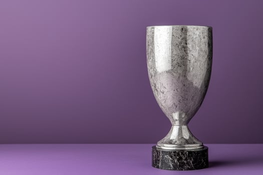 Silver trophy on a rich purple background. photo