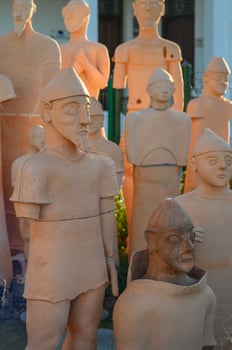 Exploring the artistry of terracotta sculptures in a vibrant outdoor exhibition photo