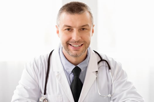 Healthcare And Medicine Concept. Close up portrait of cheerful mature MD in white coat looking at camera photo