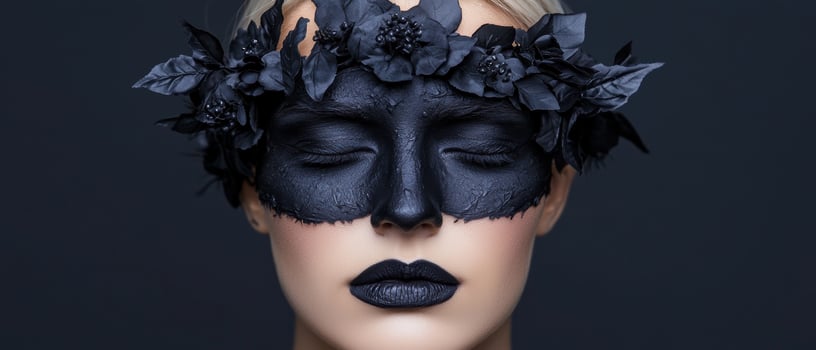 Close up of a woman wearing a black mask and flower crown photo