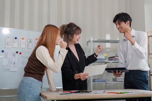 Energetic UX UI team celebrating successful design concepts during a collaborative meeting in a modern office photo