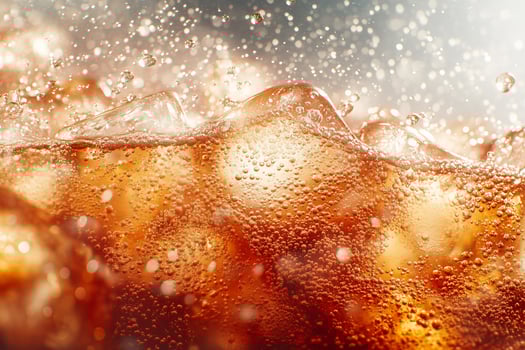 Bubbles cascade over caramel waves in a sparkling refreshment splash at sunset. photo
