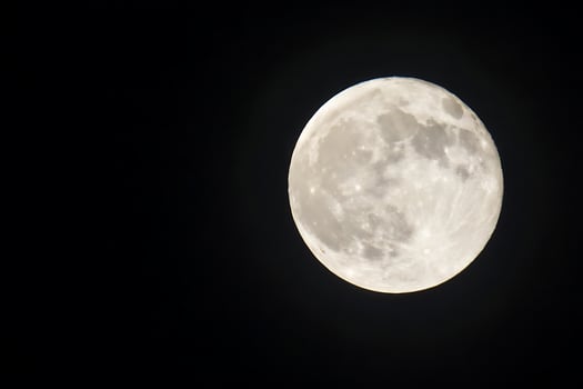 the full moon is seen in the dark sky photo