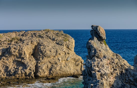 Majestic rocky coast with tranquil blue waters on a sunny day. photo