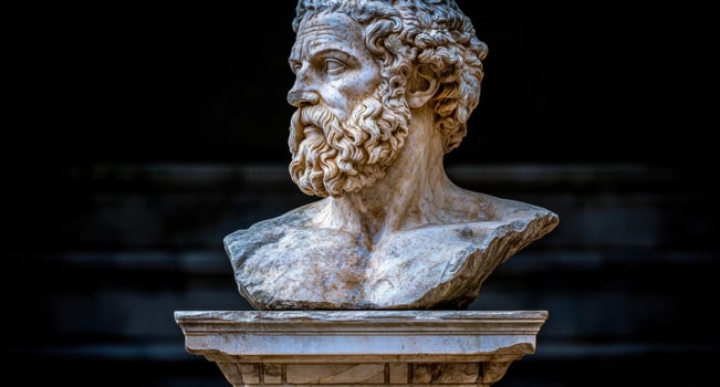 Ancient Greek bust sculpture on a stone pedestal photo